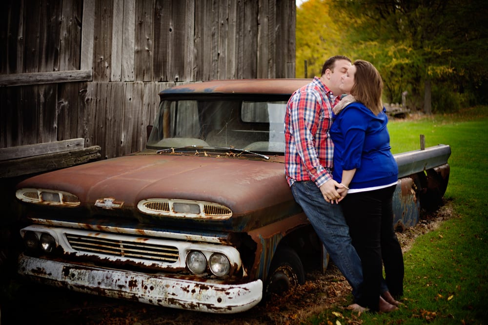 Cornwall engagement session - man in plaid shirt kissing girlfriend