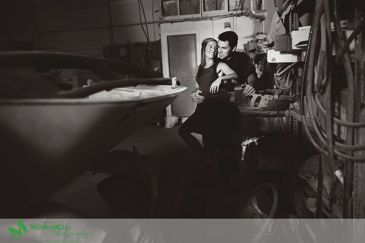 man and woman leaning on mechanic's bench - Cornwall engagement session