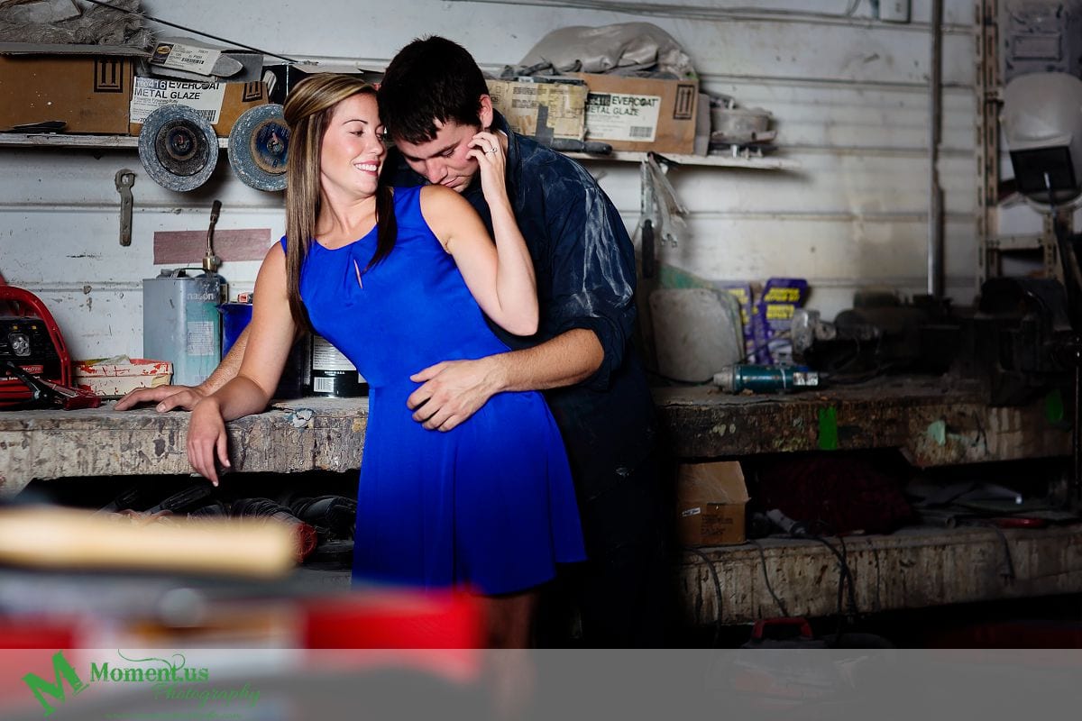 woman in blue dress elbow on workbench - Cornwall engagement session