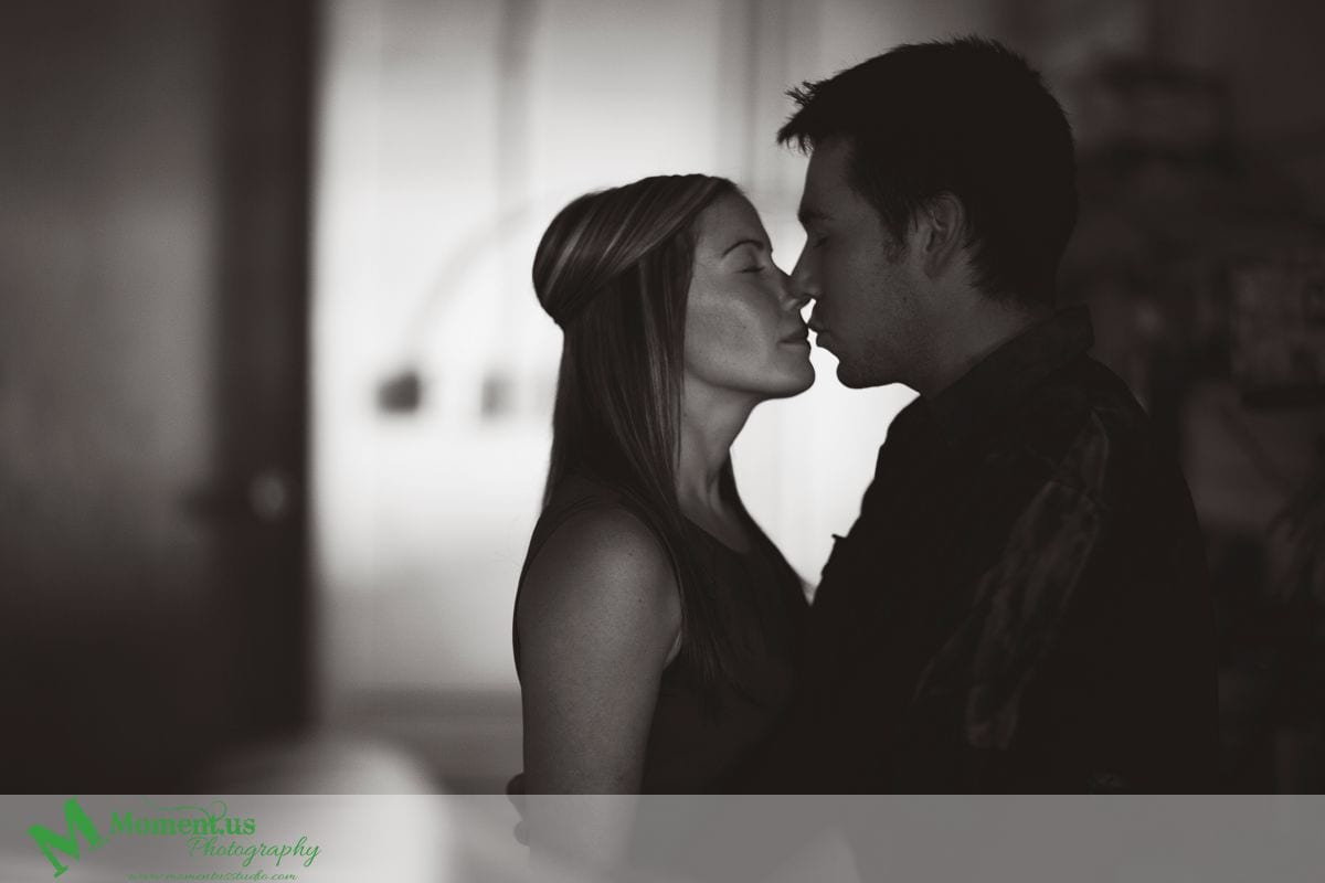 man and woman kissingin dark room - Cornwall engagement session