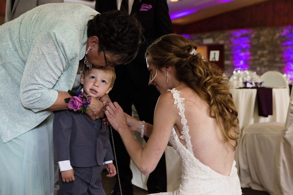 little boy having flowers adjusted ahead of Strathmere wedding ceremony