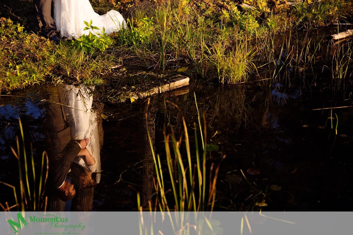 bride and groom reflected in water - Calabogie Peaks Wedding