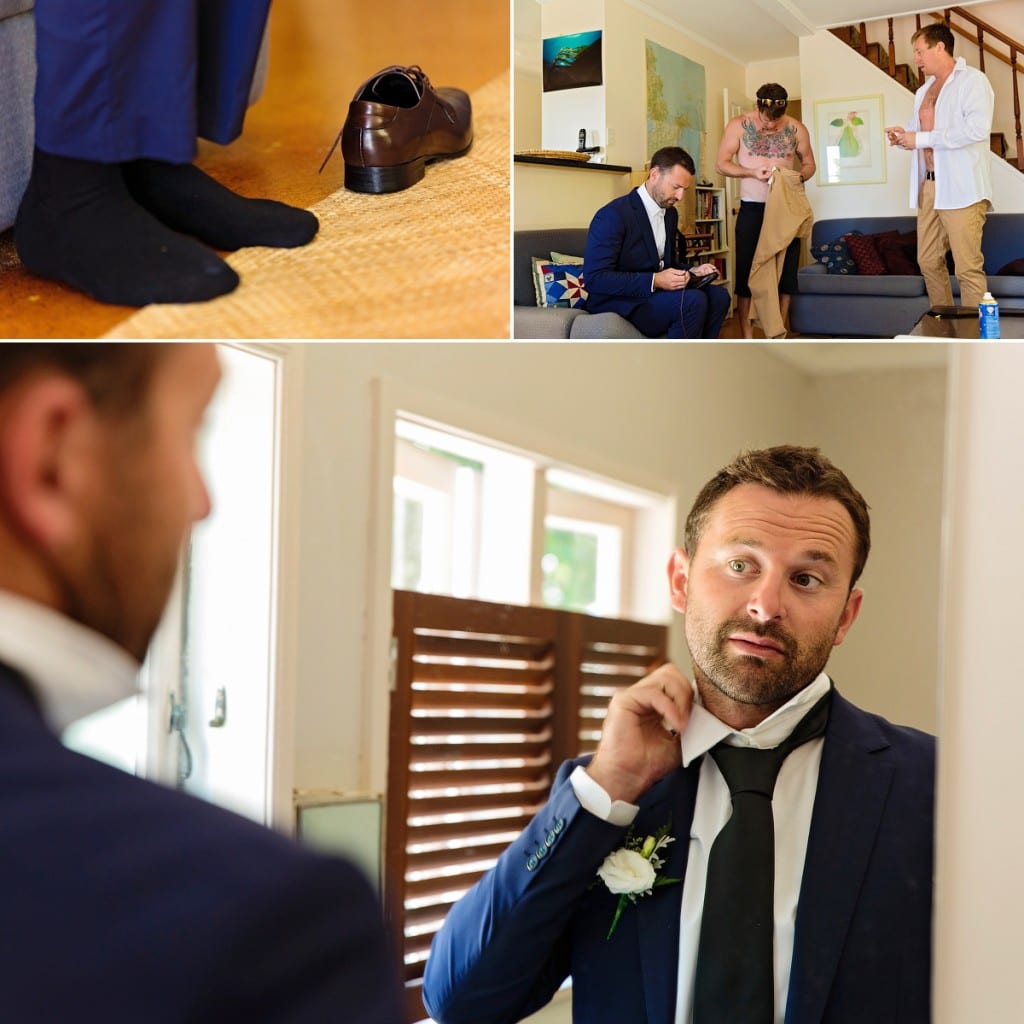 Cornwall international wedding photographer - groom fixing collar