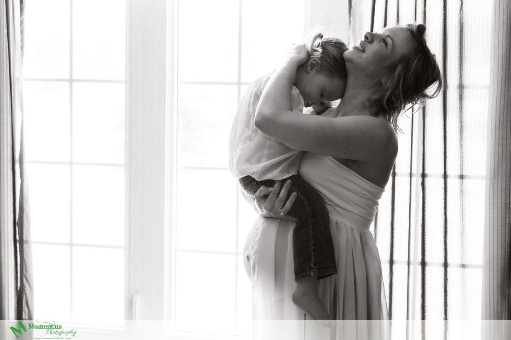 Maternity photography in Cornwall - cuddle in the window