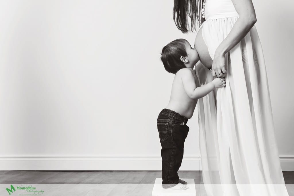 Maternity photography in Cornwall - boy kissing belly 