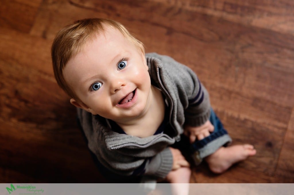 Cornwall children's photographer - smiling up in grey sweater
