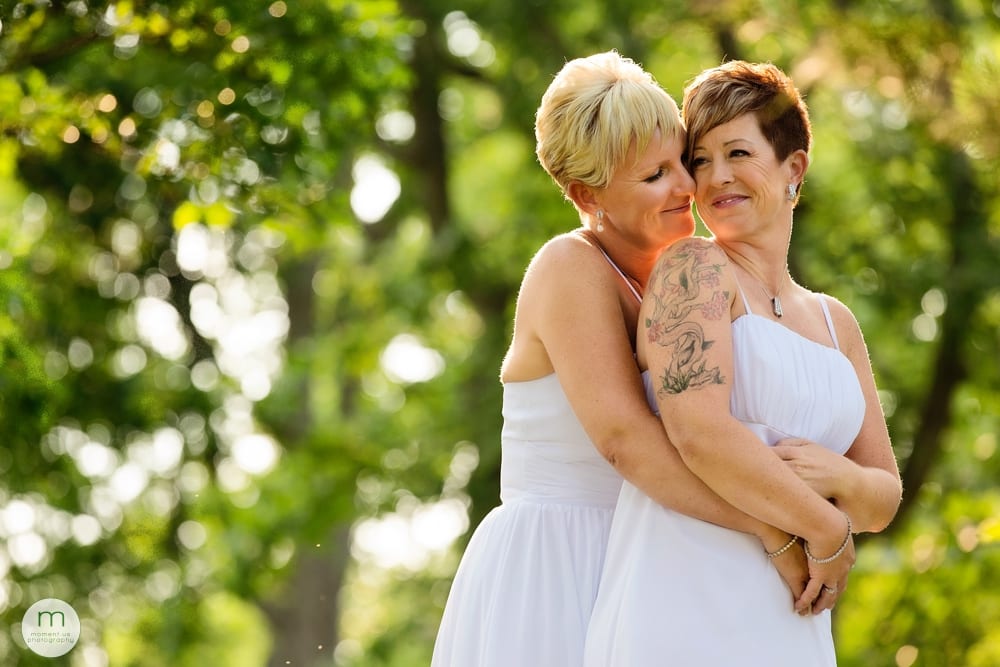 brides cuddling in trees