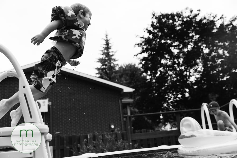 boy leaping into pool