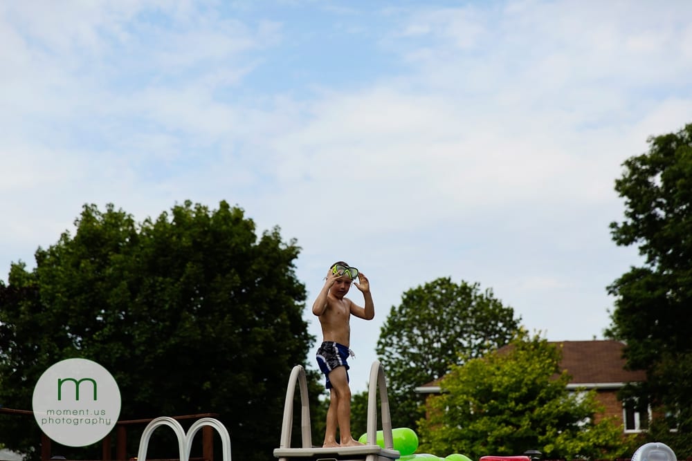 boy on pool ladder