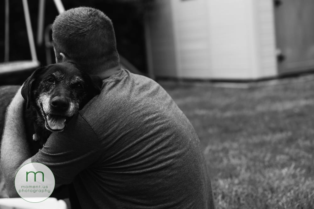 man hugging dog