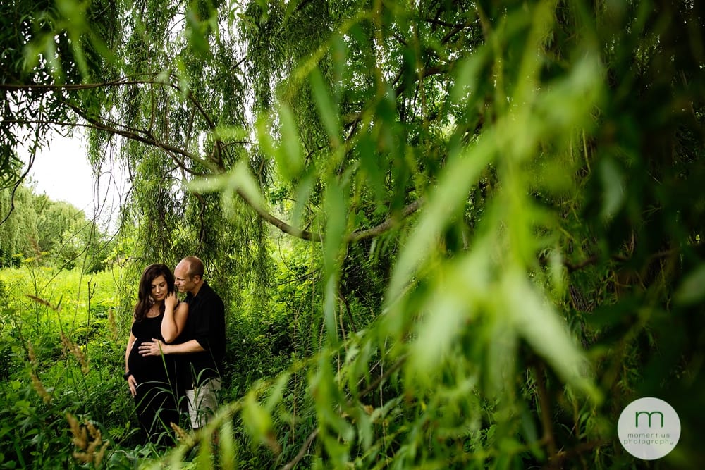 pregnant woman in black dress with husband by willow