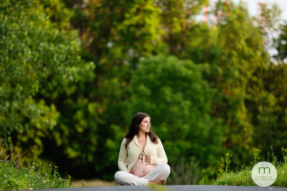 pregnant woman sitting on path