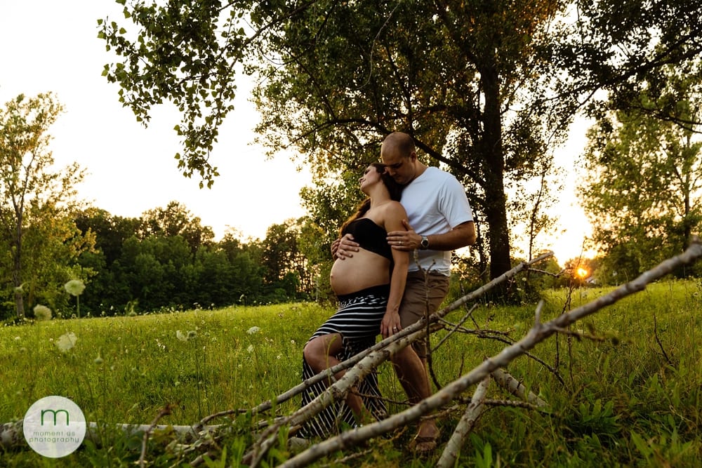 pregnant woman in tube top by fallen tree