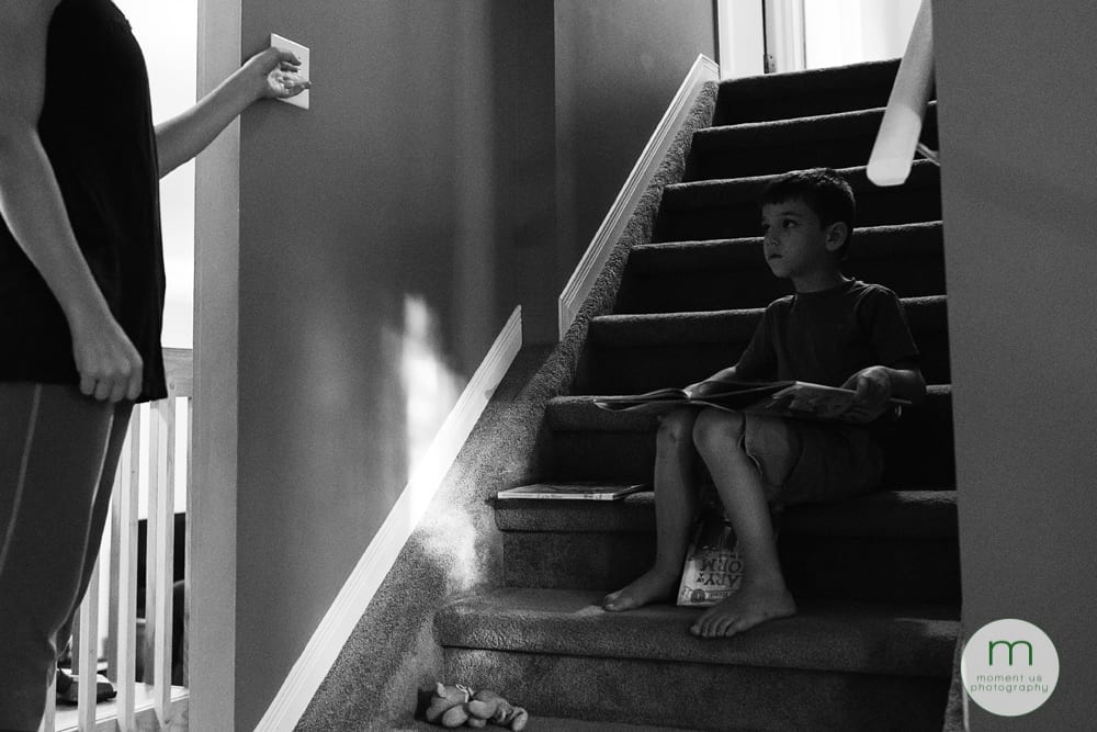 boy reading on staircase