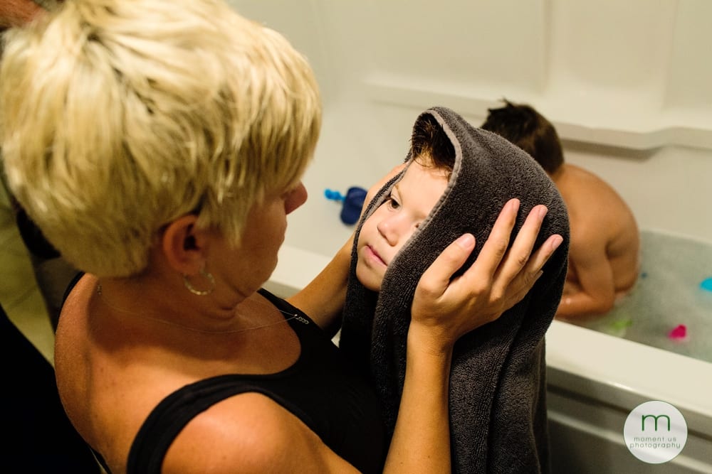 mom looking at boy in towel