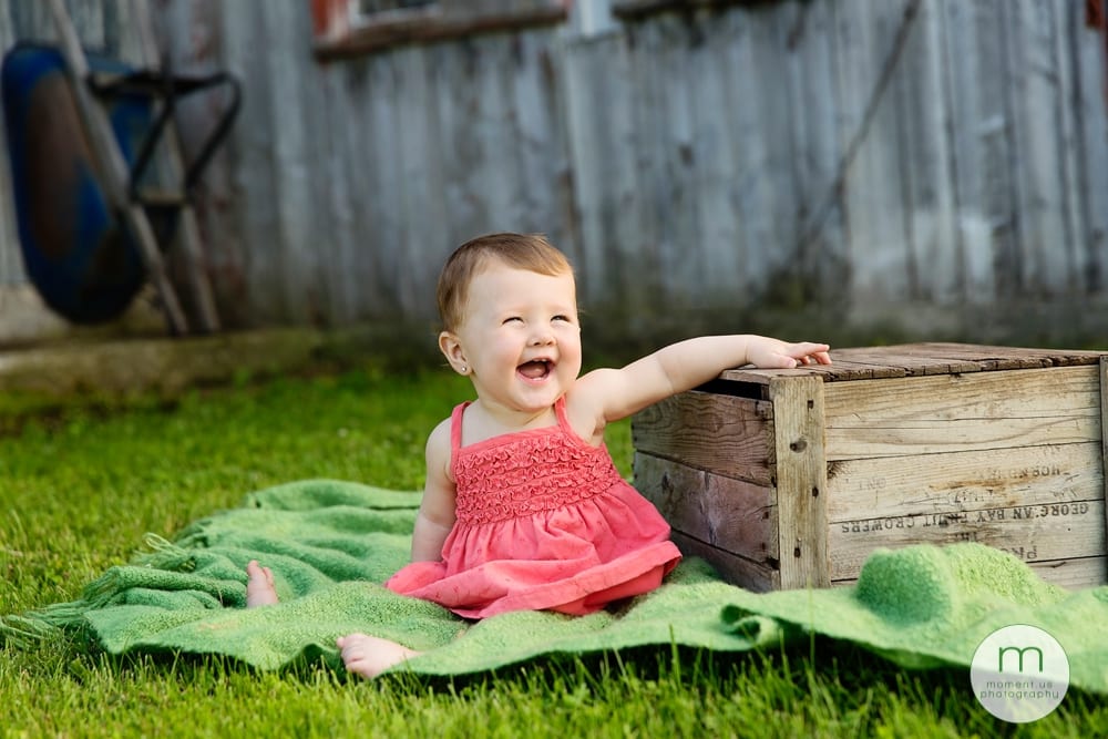 girl smiling on green blanket