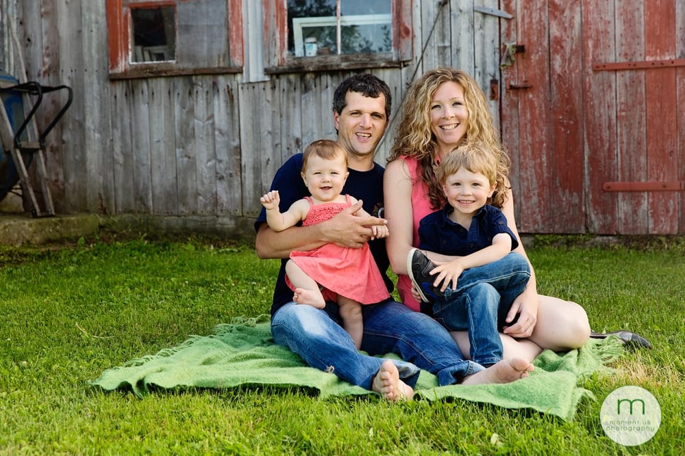 family in front of barn door