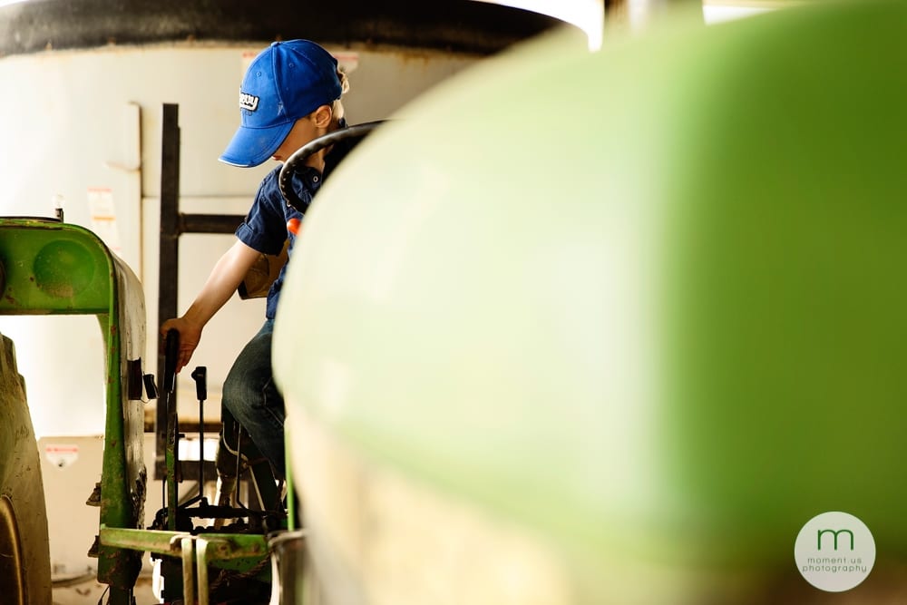 boy on green tractor