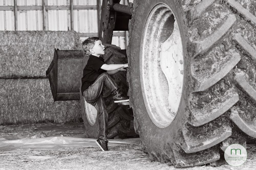 boy climbing on tractor