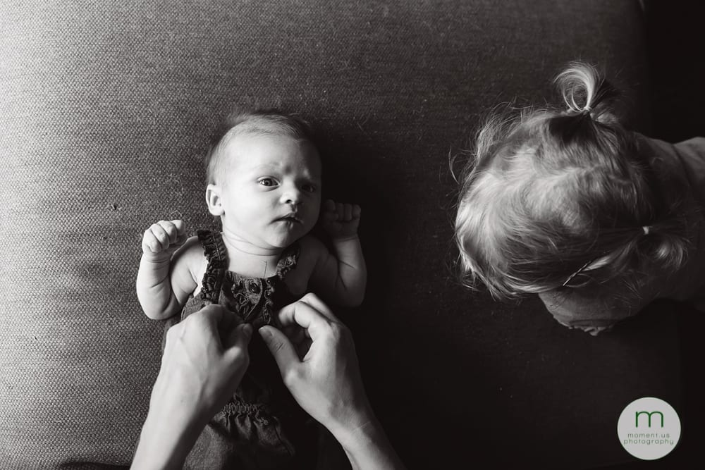 mother dressing baby