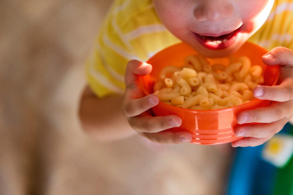boy eating macaroni