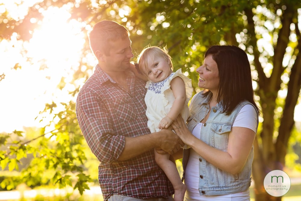 Cornwall child with mom and dad under trees