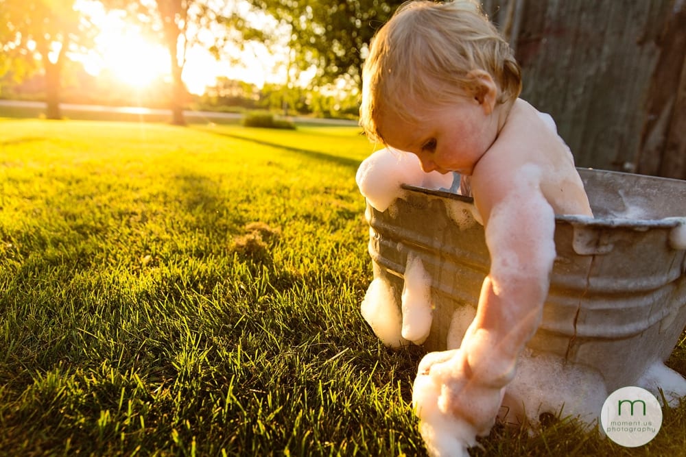 Cornwall child leaning out of tub in sunlight