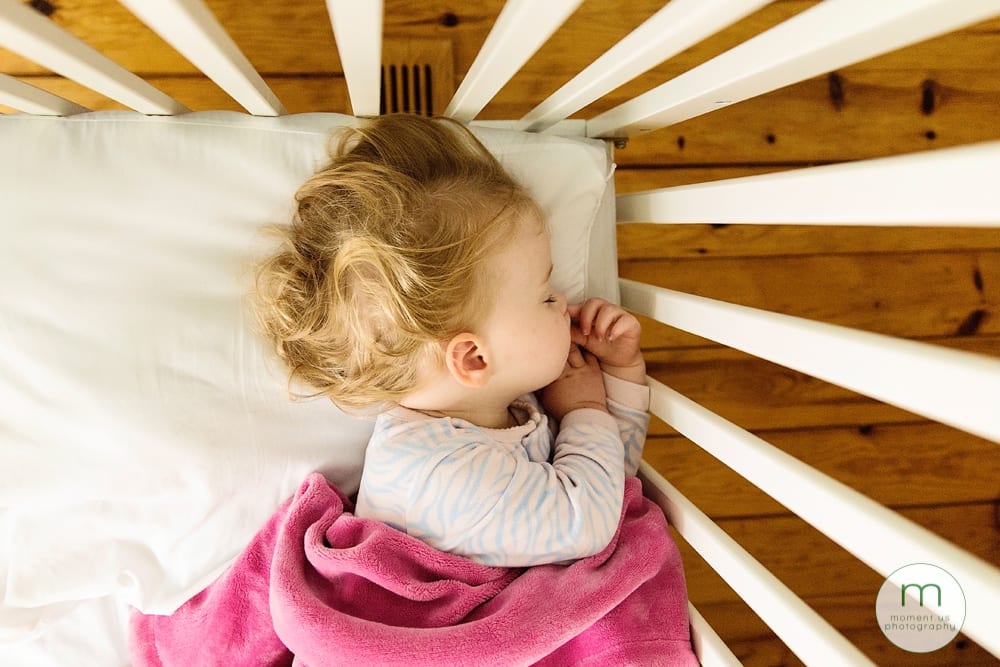 girl asleep in crib