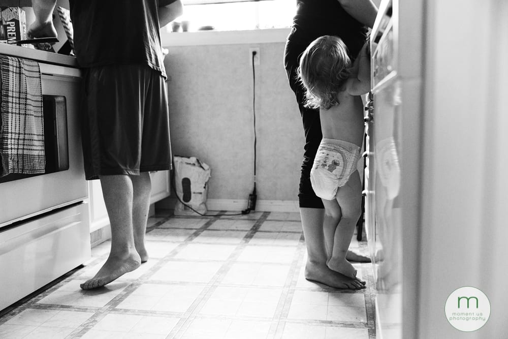 girl standing on mom's foot