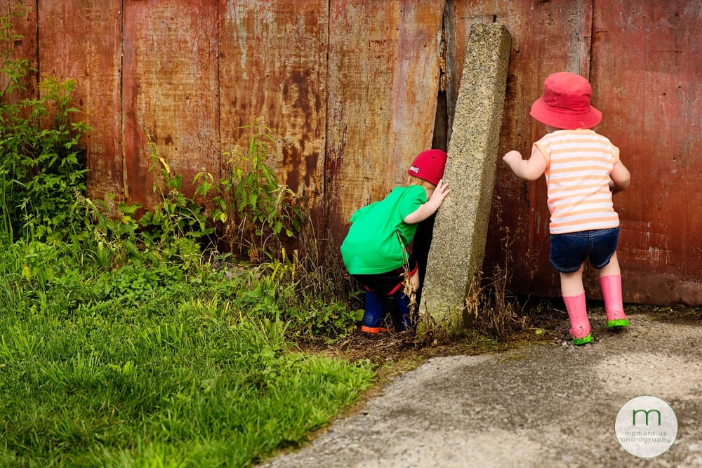 boy and girl peeking in barn