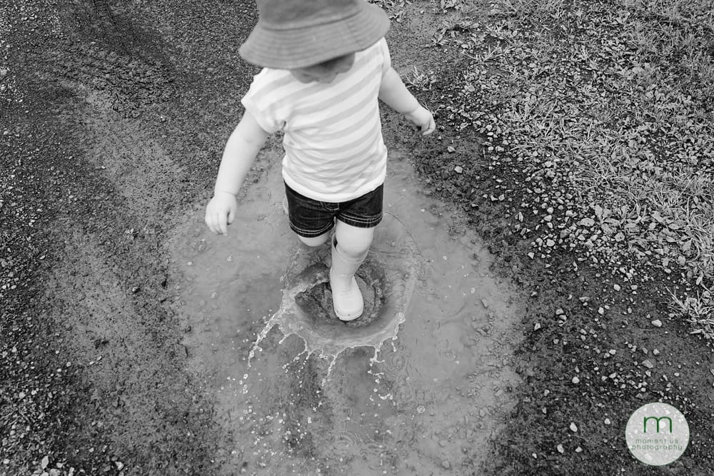 girl splashing in puddle