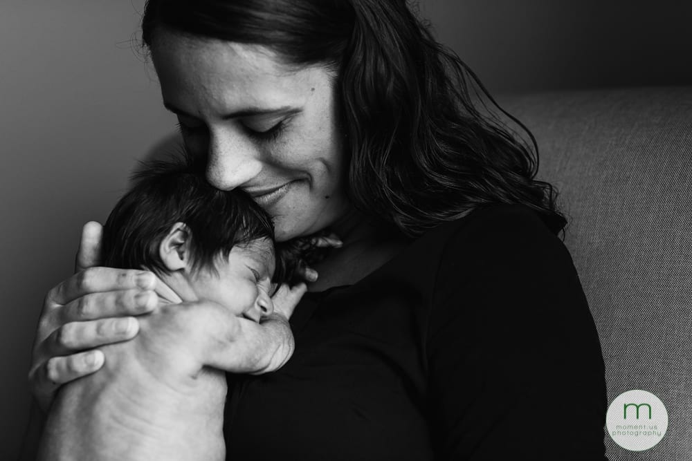 Cornwall mom cuddling newborn daughter