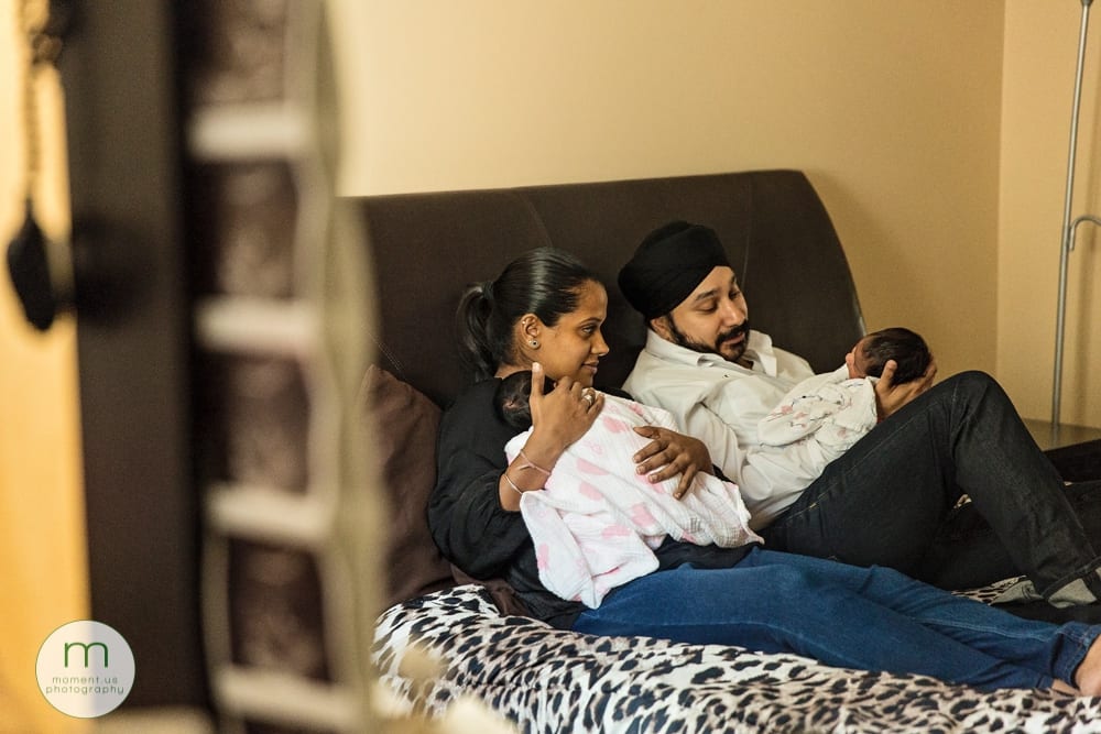 Brossard parents holding twins with sonogram photos in the mirror