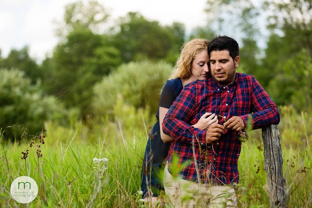 couple cuddling in grass