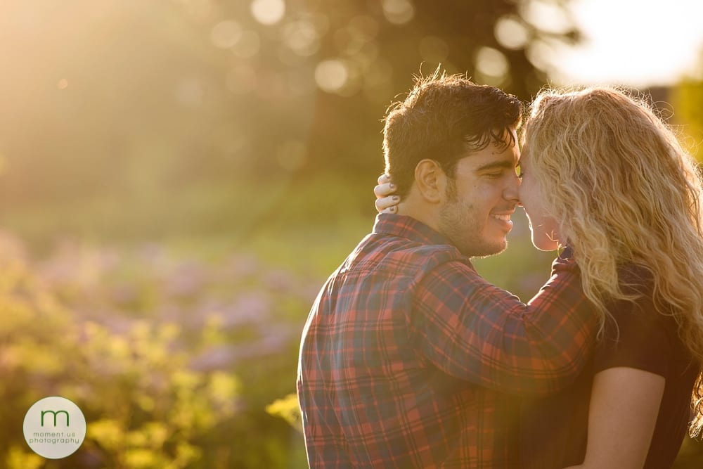 man in blue and red checked shirt with fiancee for engagement session