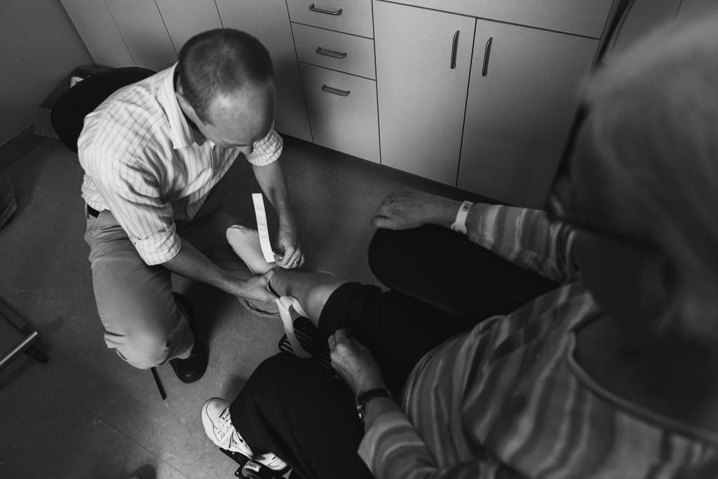doctor putting brace on woman
