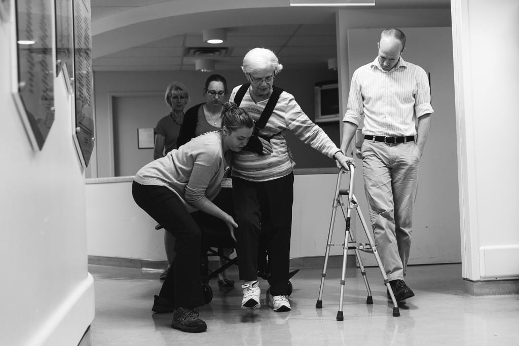 therapists helping patient walk