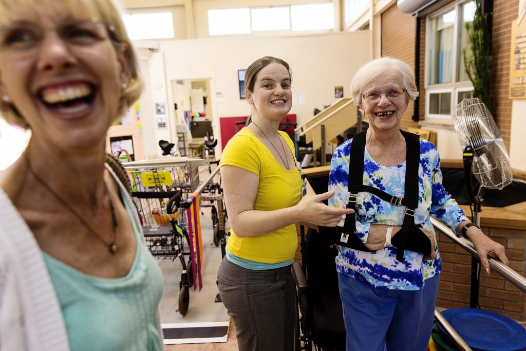 therapist laughing with standing patient