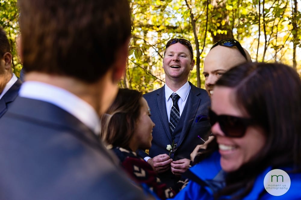 groom laughing with boutonniere