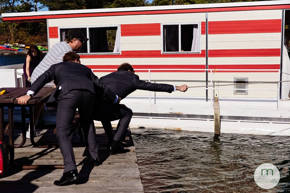groomsmen holding boat rope