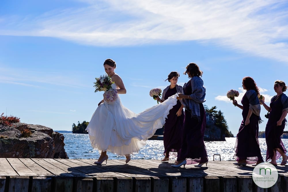 bridesmaids holding bride's dress