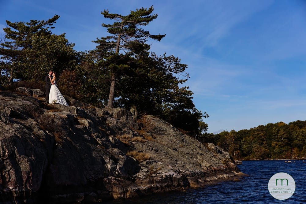 bride and groom on rocky cliff
