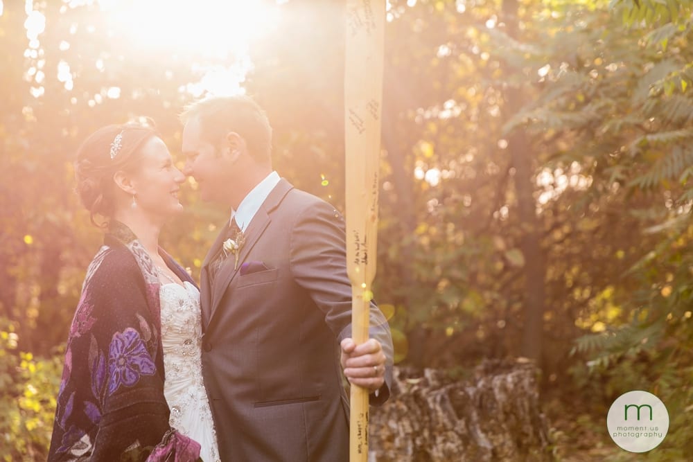 groom holding kayak paddle