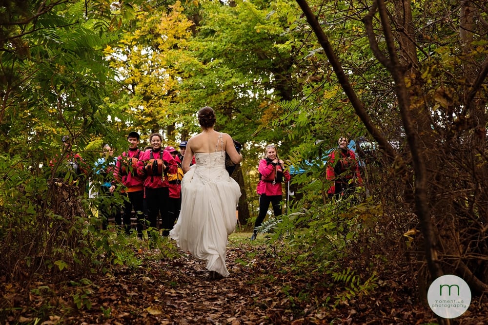 bride walking towards kayakers