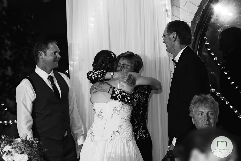 groom's mother hugging bride