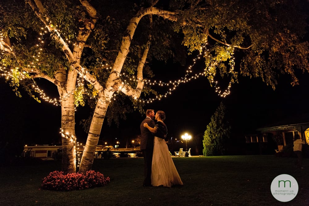 bride and groom dancing under tree