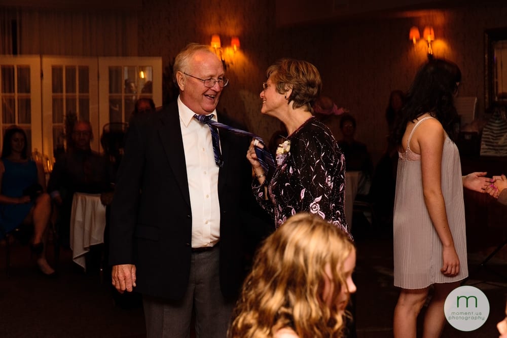 woman pulling man's tie