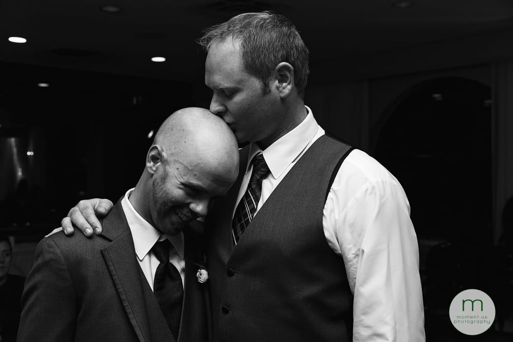 groom kissing friend's head