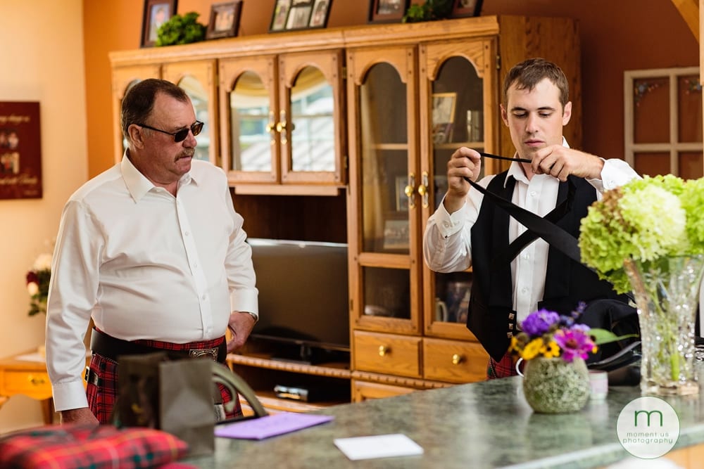 Cornwall Rustic Country Wedding groom tying tie