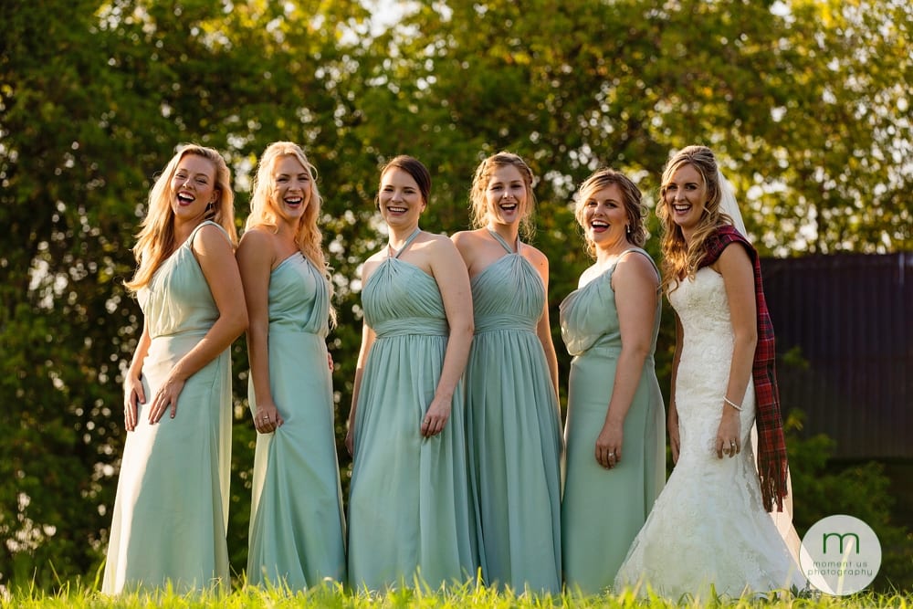 Cornwall Rustic Country Wedding - bride with bridesmaids in grass